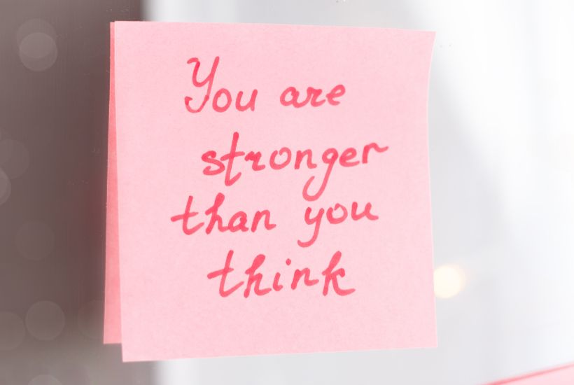 Affirmation on a post it note saying "you are stronger than you think"