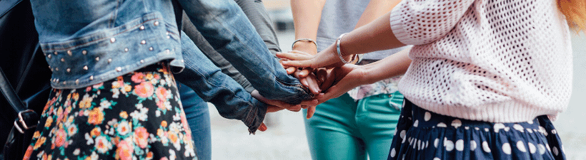 A group of friends holding hands and supporting each others