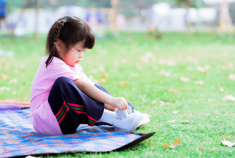 Toddler being patient while putting shoes on