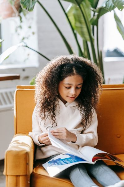 Child focuses on a book- helping a child to focus
