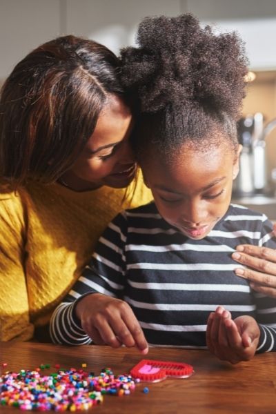 A mum helping child to feel confident