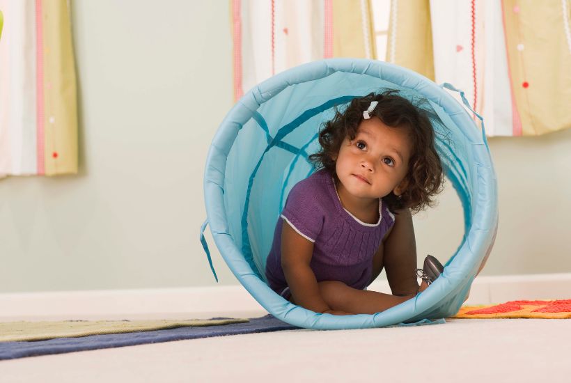 Toddler development - child playing hide and seek
